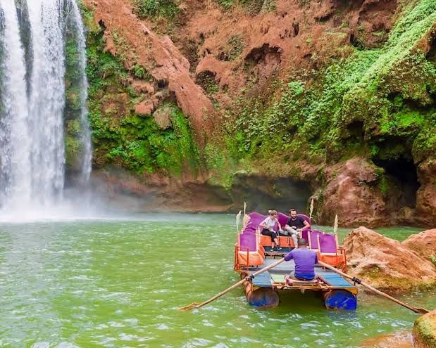 Traditional decorated raft carrying visitors at the foot of the Ouzoud Waterfalls