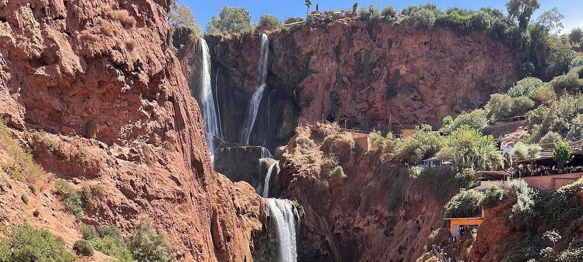 Red cliffs and the falls seen from the top of the Ouzoud gorge